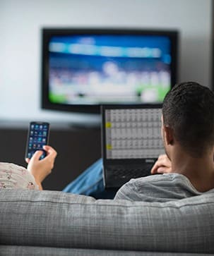 A man sitting on the couch watching tv