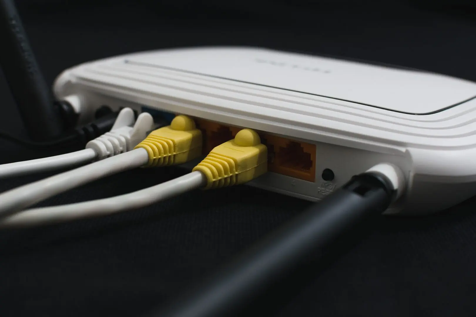 A white box with four yellow plugs connected to it.