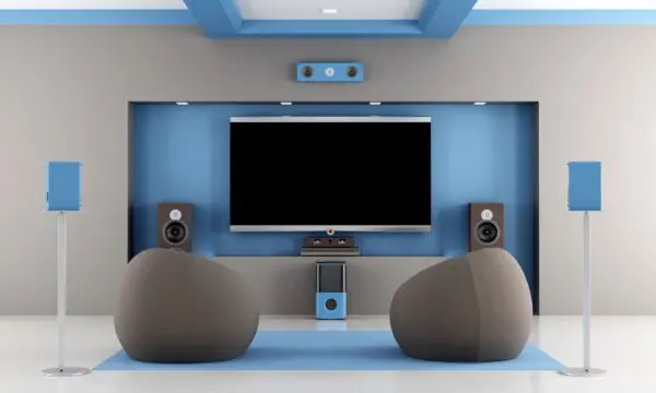 A room with two large chairs and a television.