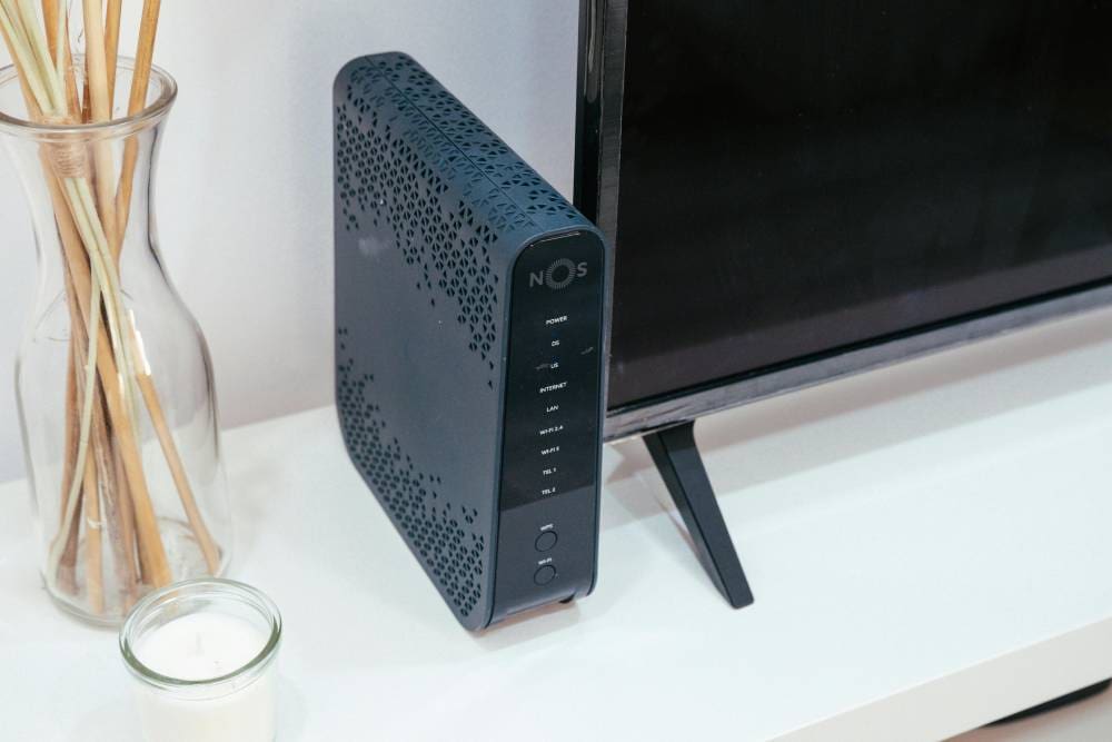 A black and blue router sitting on top of a table.